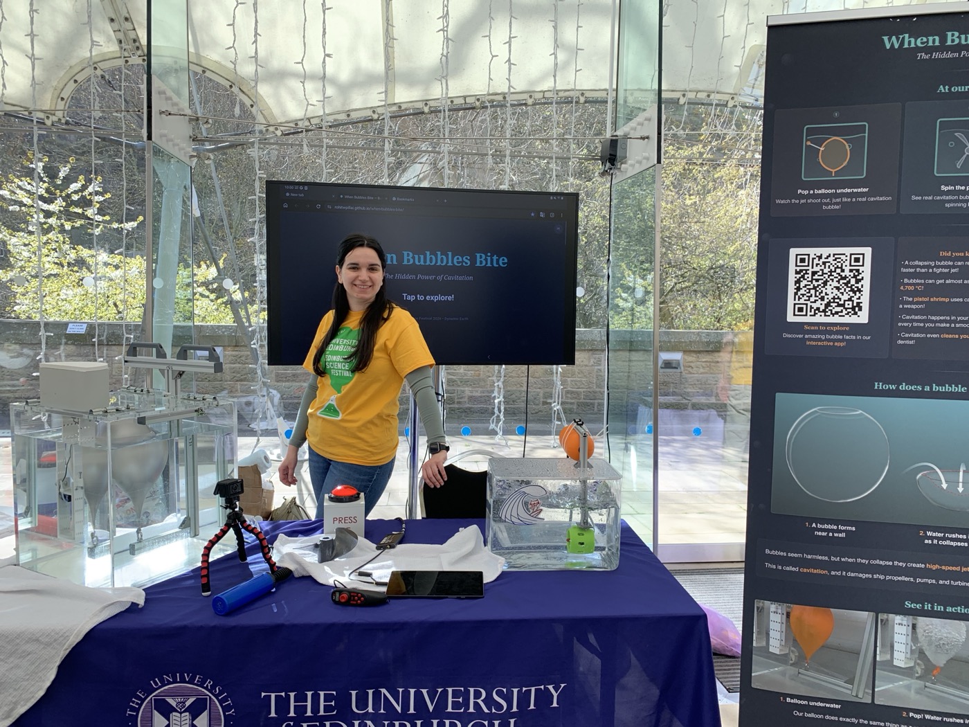 A volunteer demonstrating the interactive app at the stand
